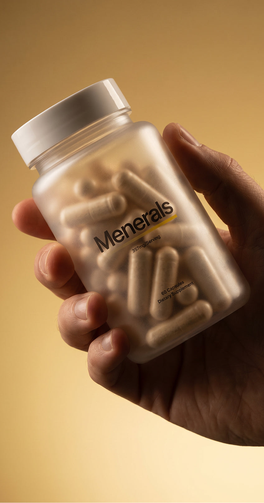 Hand holding Menerals supplement bottle