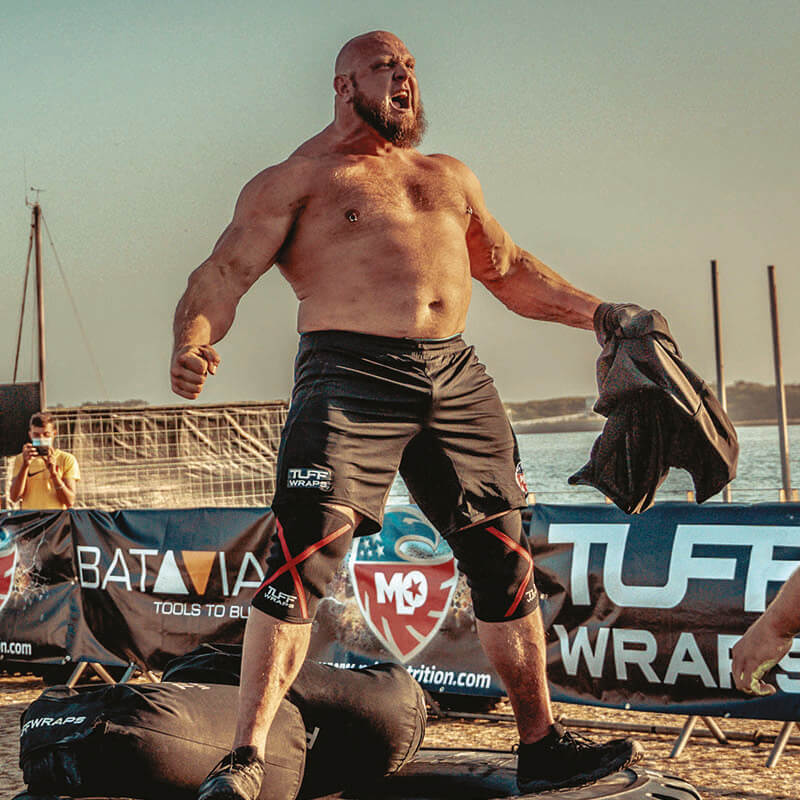 Travis Ortmayer mid-competition after a sandbag lift